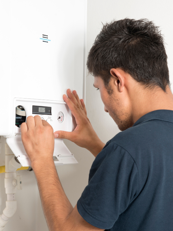 Engineer adjusts the settings on the front display of the boiler - south woodham ferrers