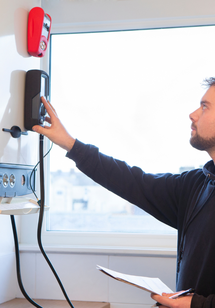 Technician inspects a boiler - boiler installations Chelmsford